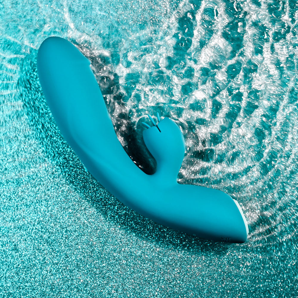 USB rechargeable rabbit vibrator floating in water, showcasing its vibrant color and sleek design.