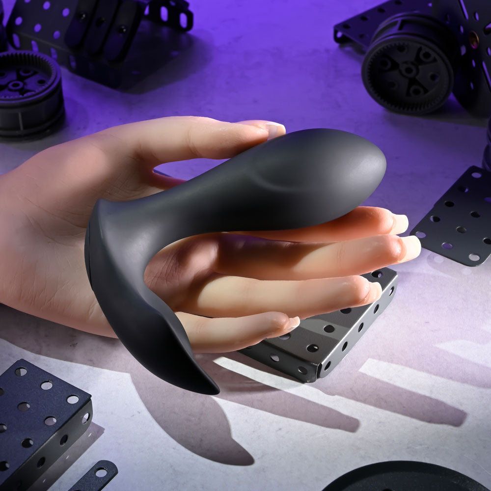 Evolved TAKE ME OUT wearable vibrators with remote control in a hand, showcasing its sleek design and portability.