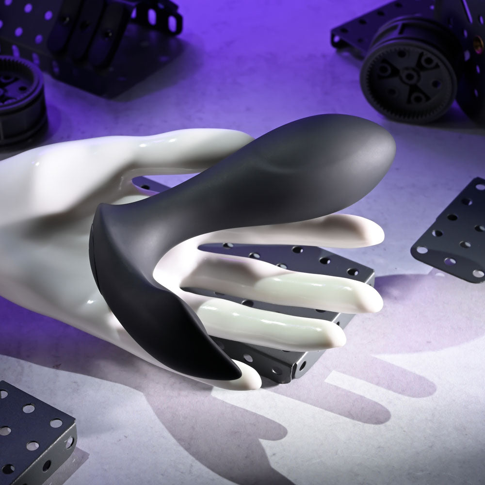 Evolved TAKE ME OUT -  USB Rechargeable Wearable Vibrator with Remote Control on a mannequin hand with a modern background.