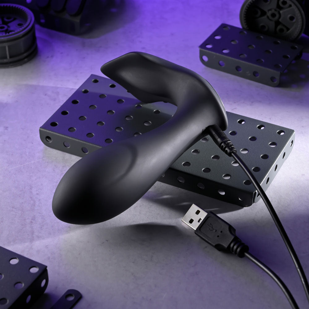 Evolved TAKE ME OUT - USB Rechargeable Wearable Vibrator with Remote Control on a textured surface with a USB cable.