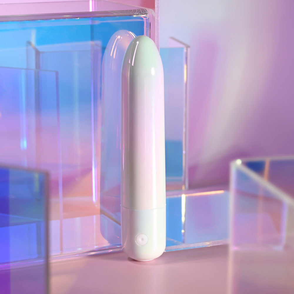 Evolved EASY DOES IT - Pearlescent 10 cm USB Rechargeable Bullet among colorful geometric shapes.