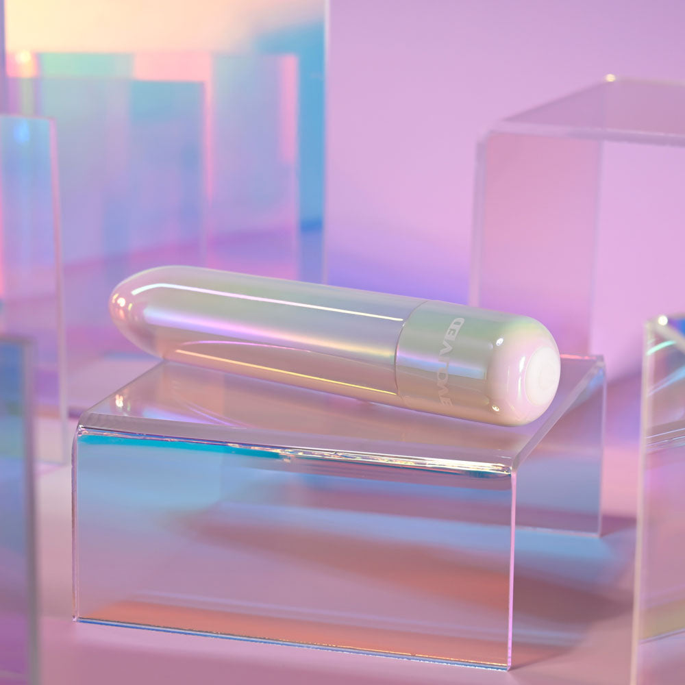Evolved EASY DOES IT - Pearlescent 10 cm USB Rechargeable Bullet on a clear display block with iridescent background.
