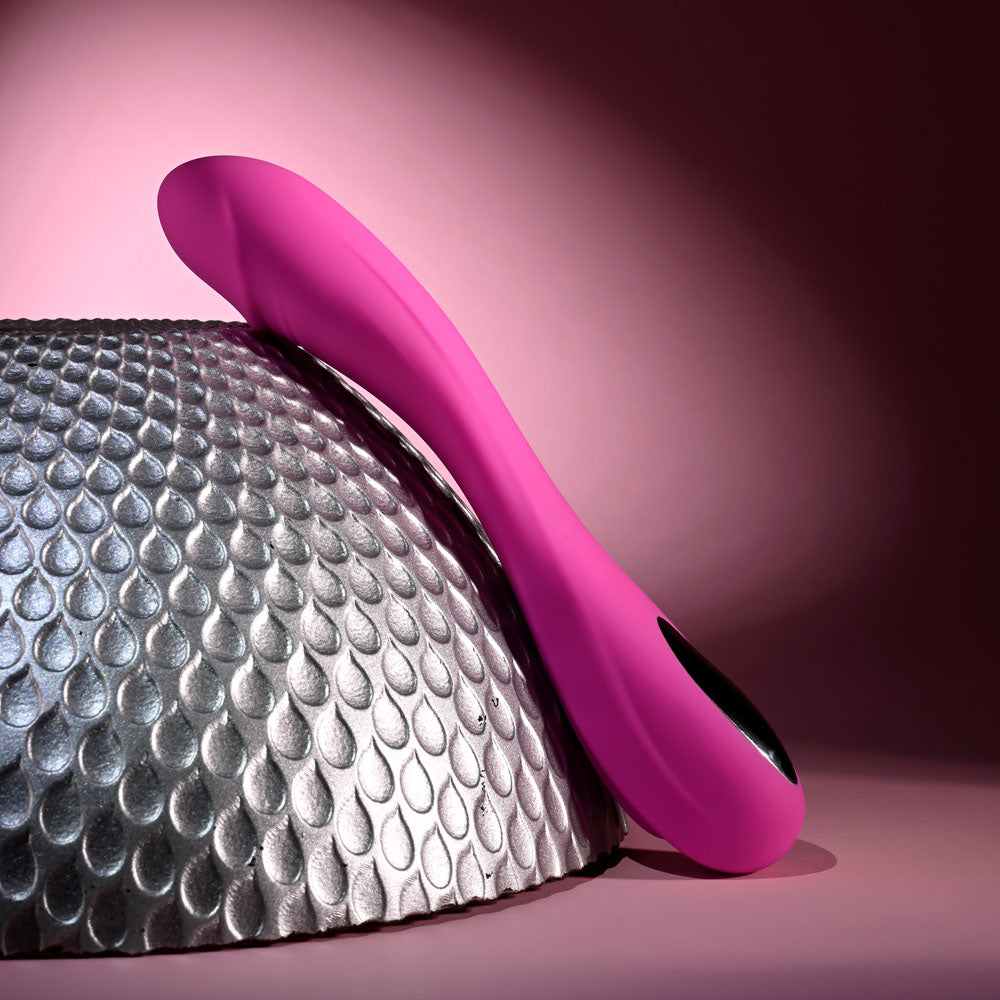 Evolved SUGAR RUSH - 21.6 cm USB Rechargeable Vibrator on textured surface with elegant design.