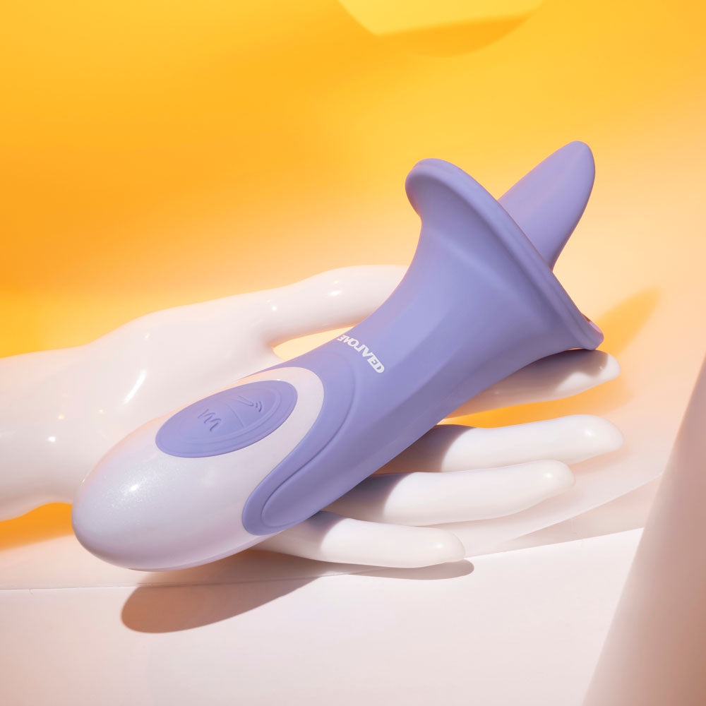 Evolved LIX & KISSES -  18.7 cm USB Rechargeable Flicking Tongue Stimulator on a white hand with a colorful background.