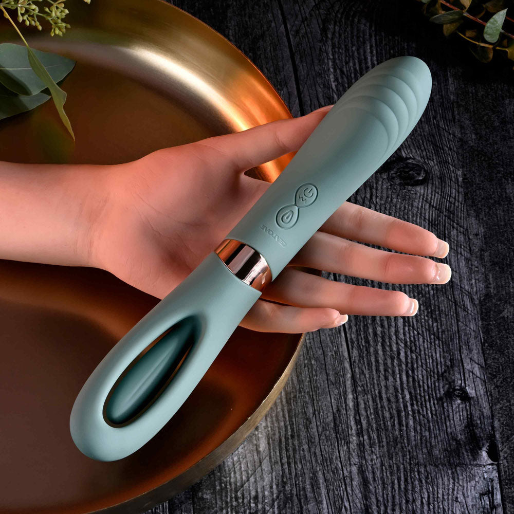 Evolved CHICK FLICK - Olive USB rechargeable vibrator with flicking tip held in hand.