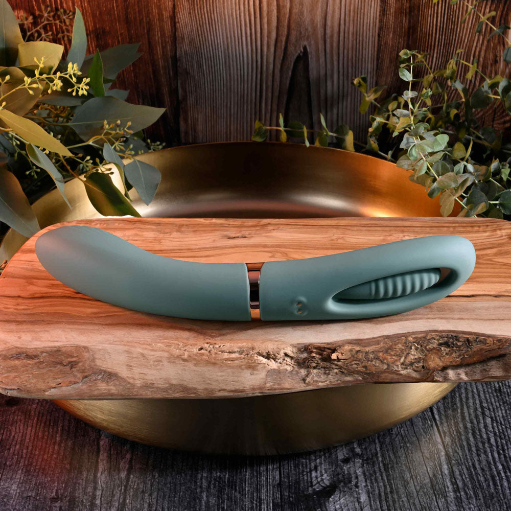 Evolved CHICK FLICK - Olive 24 cm USB Rechargeable Vibrator with Flicking Tip showcased on a wooden surface.