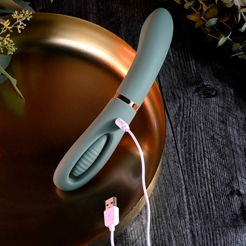 Evolved CHICK FLICK - Olive 24 cm USB Rechargeable Vibrator with Flicking Tip on a golden plate.