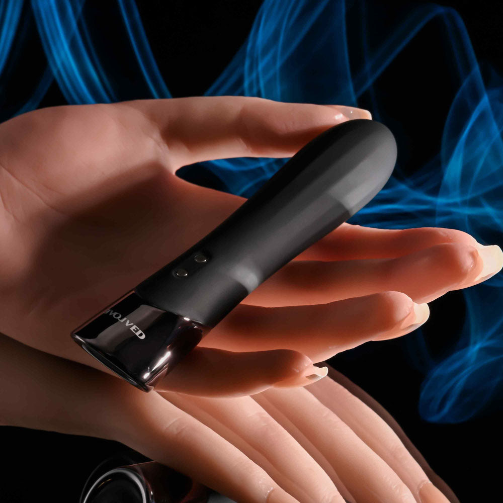 Evolved BACK IN  -  11.9 cm USB Rechargeable Bullet on a hand with smoky blue background, intimate essentials for her.
