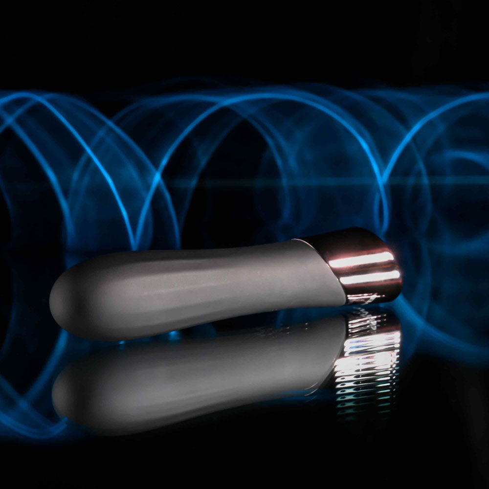 Evolved BACK IN  -  11.9 cm USB Rechargeable Bullet on a reflective surface with blue light effects.