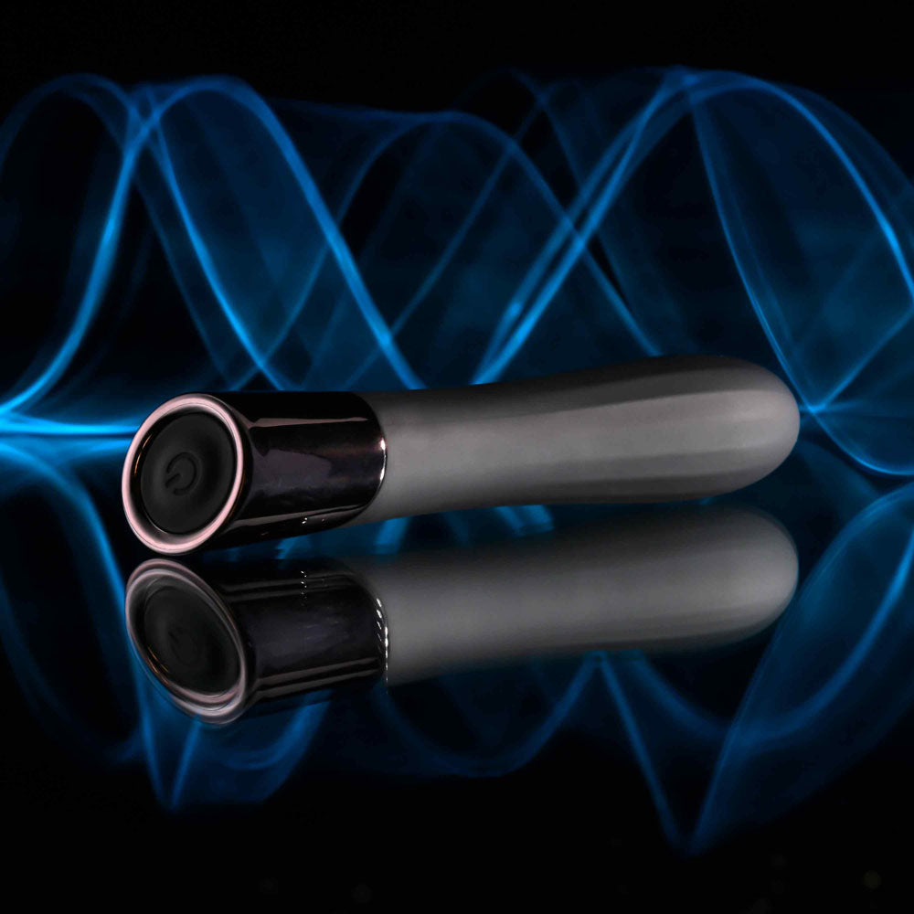 Evolved BACK IN  -  11.9 cm USB Rechargeable Bullet on a reflective surface with blue light waves.