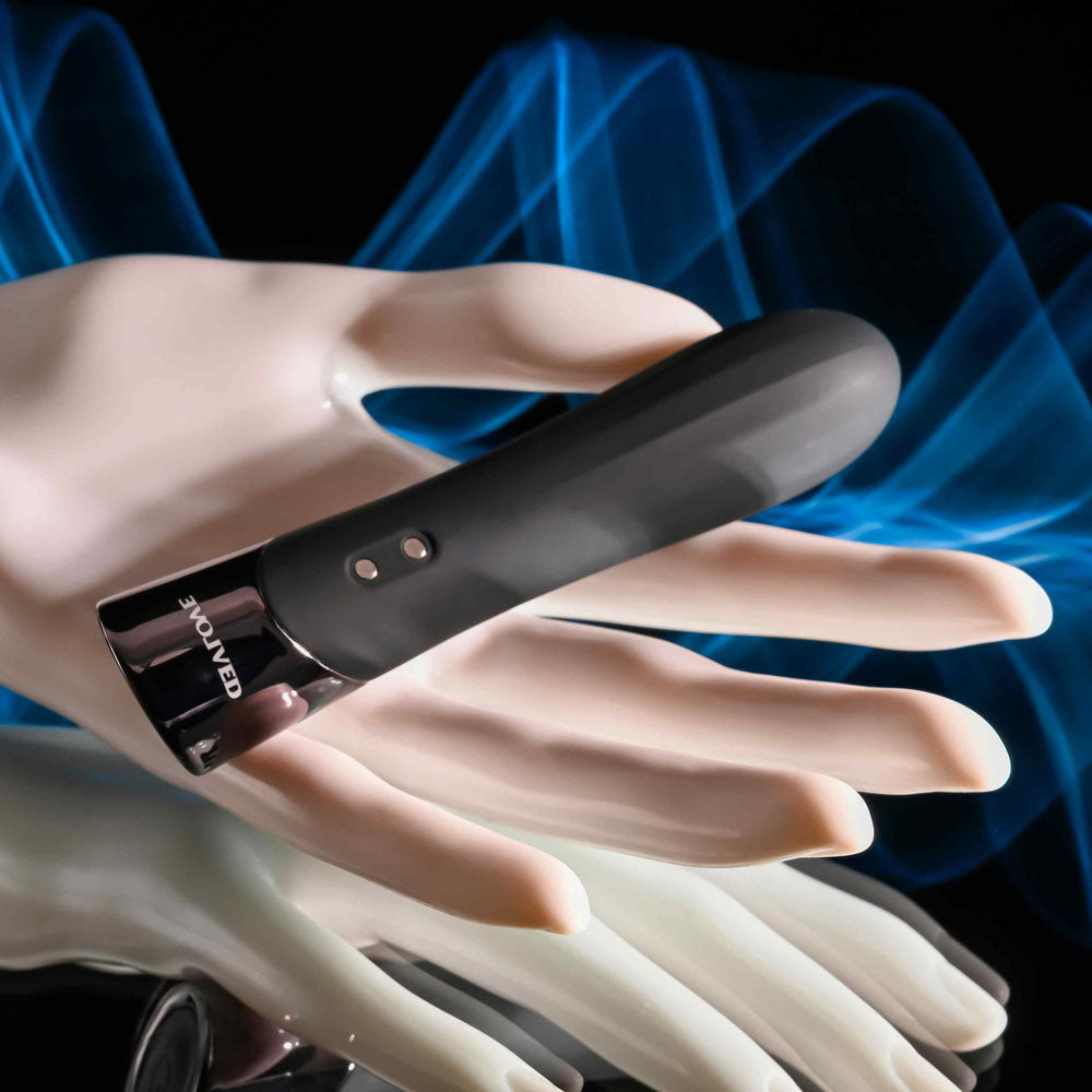 Evolved BACK IN  -  11.9 cm USB Rechargeable Bullet on a hand against an artistic blue background.