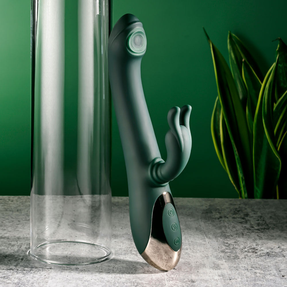 Evolved RABBIT TAP TAP -  25 cm USB Rechargeable Rabbit Vibrator with Tapping Tip standing beside a glass tube.
