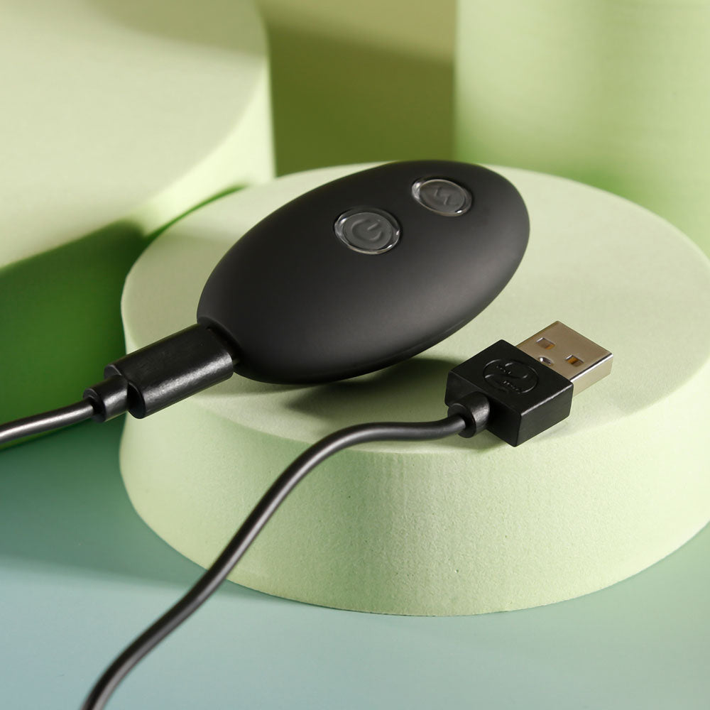 Evolved BEAD ME UP -  16.8 cm USB Rechargeable Vibrating Anal Beads with Wireless Remote charging controller on a pastel surface.