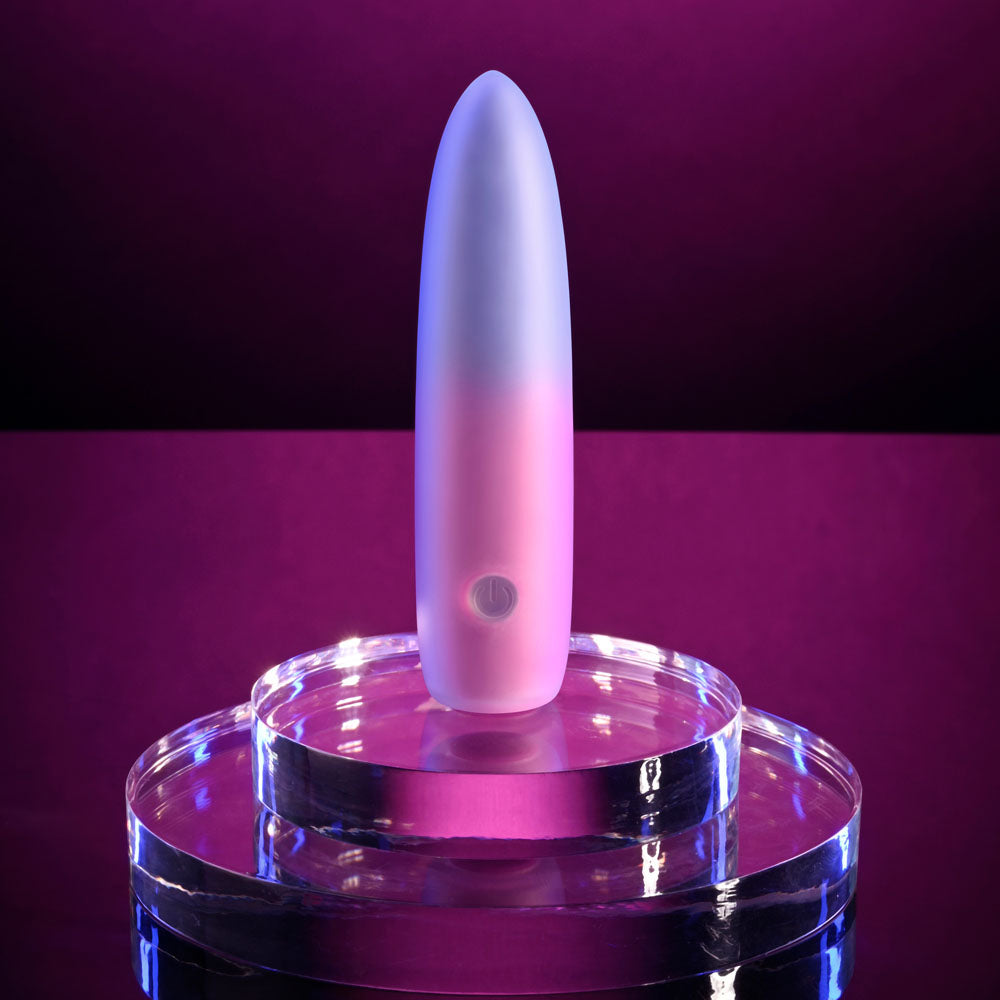 Evolved PARADISE BULLET - Pink/Purple 10.2 cm USB Rechargeable Bullet on a reflective surface with a purple background.