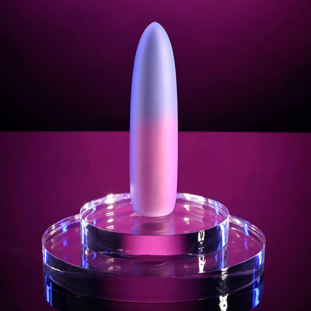 Evolved PARADISE BULLET - Pink/Purple 10.2 cm USB Rechargeable Bullet displayed on a clear platform with a purple background.