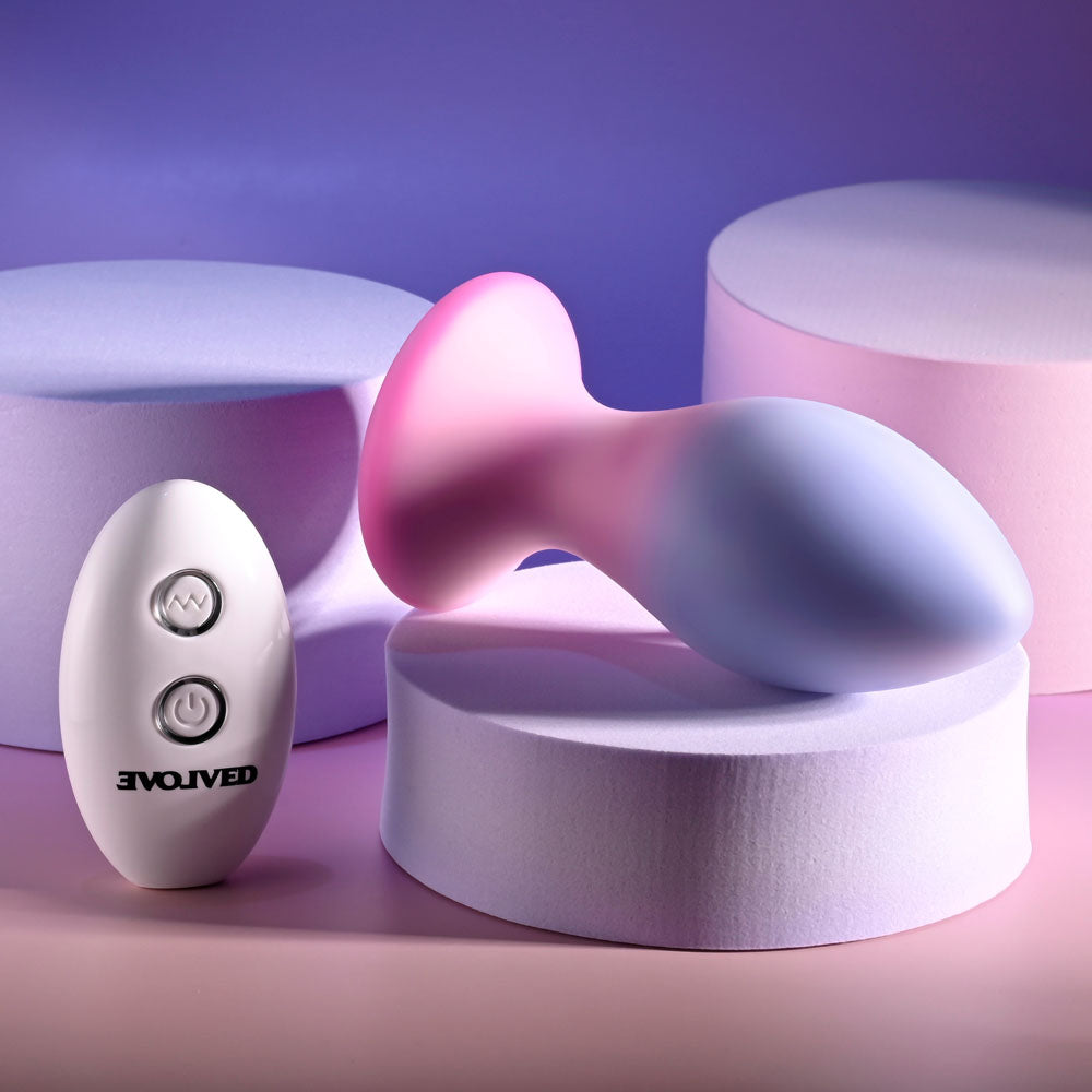 Evolved PARADISE PLUG - Pink/Purple 10.5 cm USB Rechargeable Vibrating Butt Plug with Wireless Remote on pastel background.