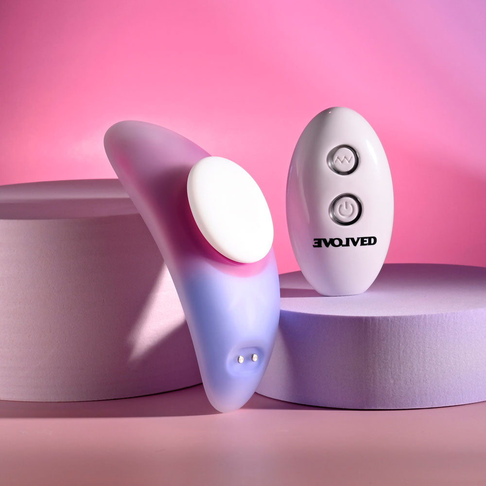 Evolved PARADISE PANTY - Pink/Purple USB Rechargeable Panty Vibrator with Remote Control on soft pastel background.