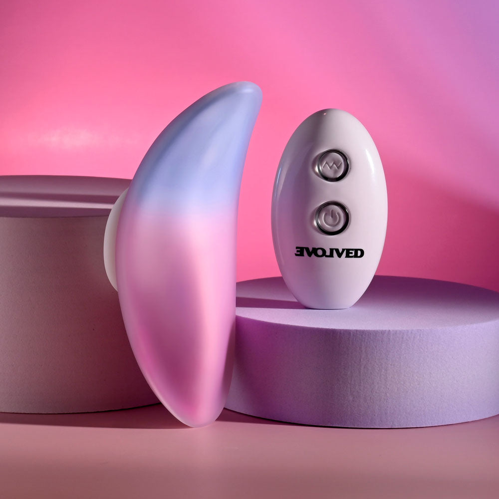 Evolved PARADISE PANTY - Pink/Purple USB Rechargeable Panty Vibrator with Remote Control on pink and purple background.