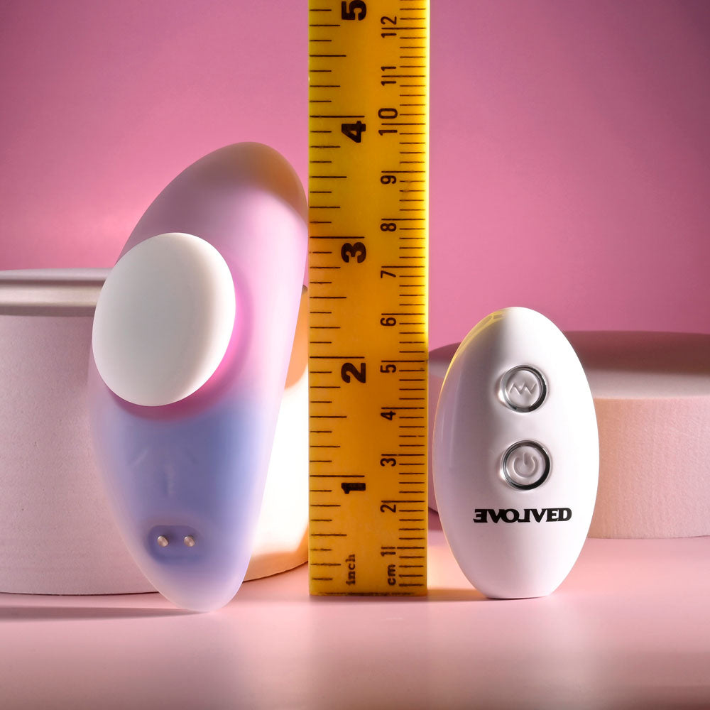 Evolved PARADISE PANTY - Pink/Purple USB Rechargeable Panty Vibrator with Remote Control next to a ruler for size reference.