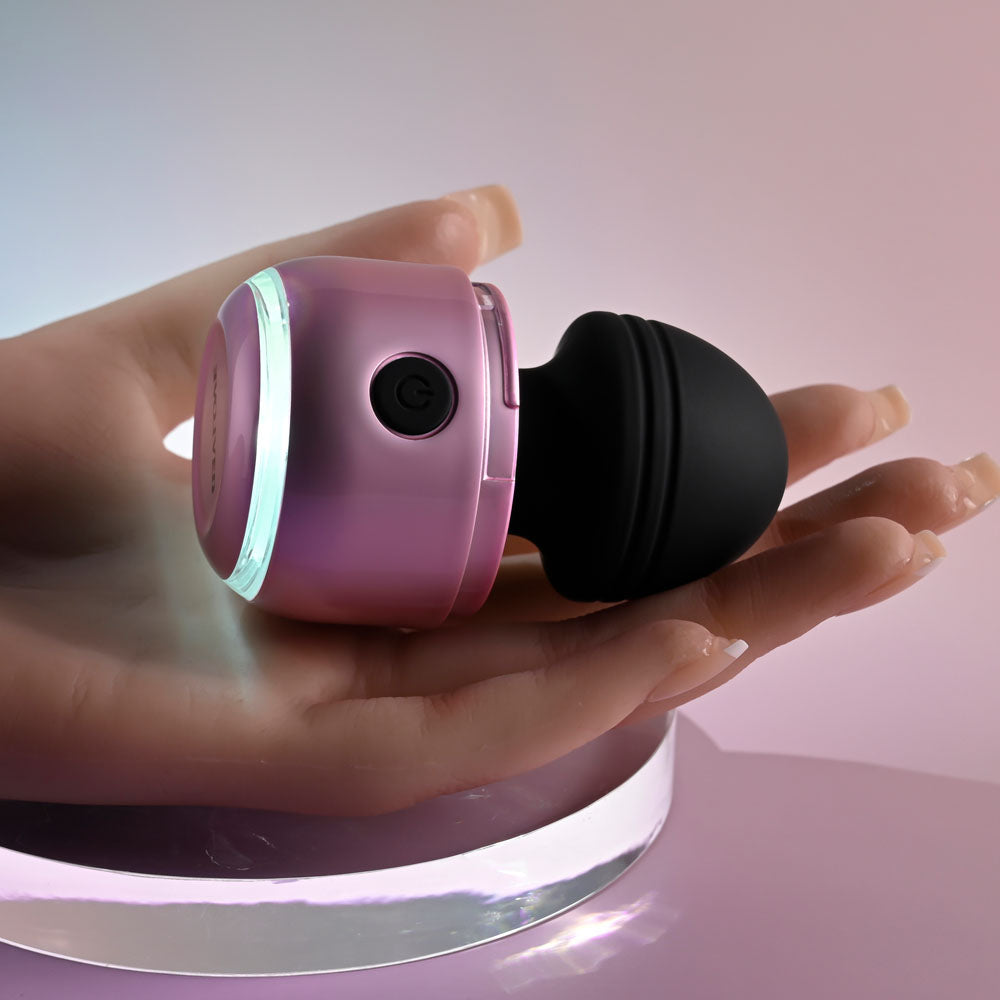 Evolved VACATION VIBES - VIBRATING - /Black 8.5 cm USB Rechargeable Vibrating Stimulator in a hand with pink and black design.