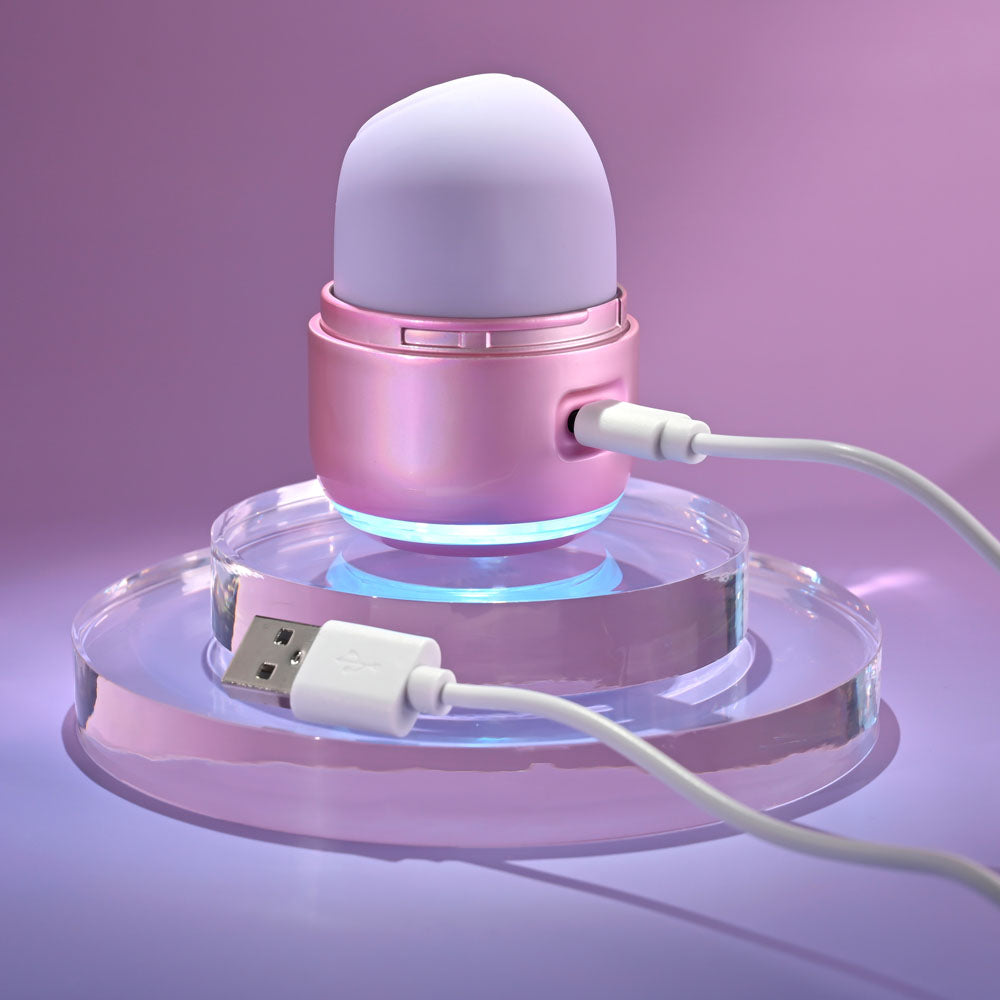 Evolved VACATION VIBES - TAPPING - 8.5 cm USB Rechargeable Tapping Stimulator on a glossy surface with charging cable.
