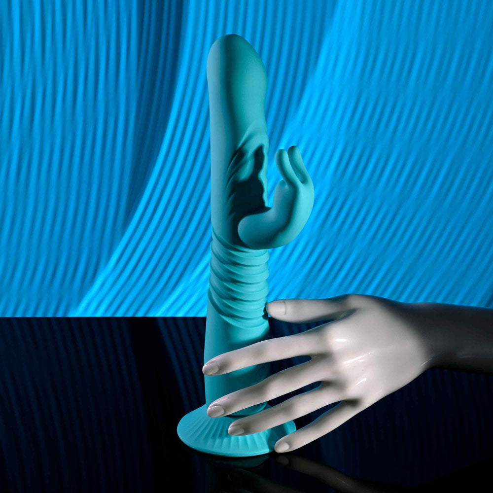 Evolved BUNNY HOP - Teal 25.1 cm USB Rechargeable Thrusting Rabbit Vibrator with Suction Base displayed against a blue background.