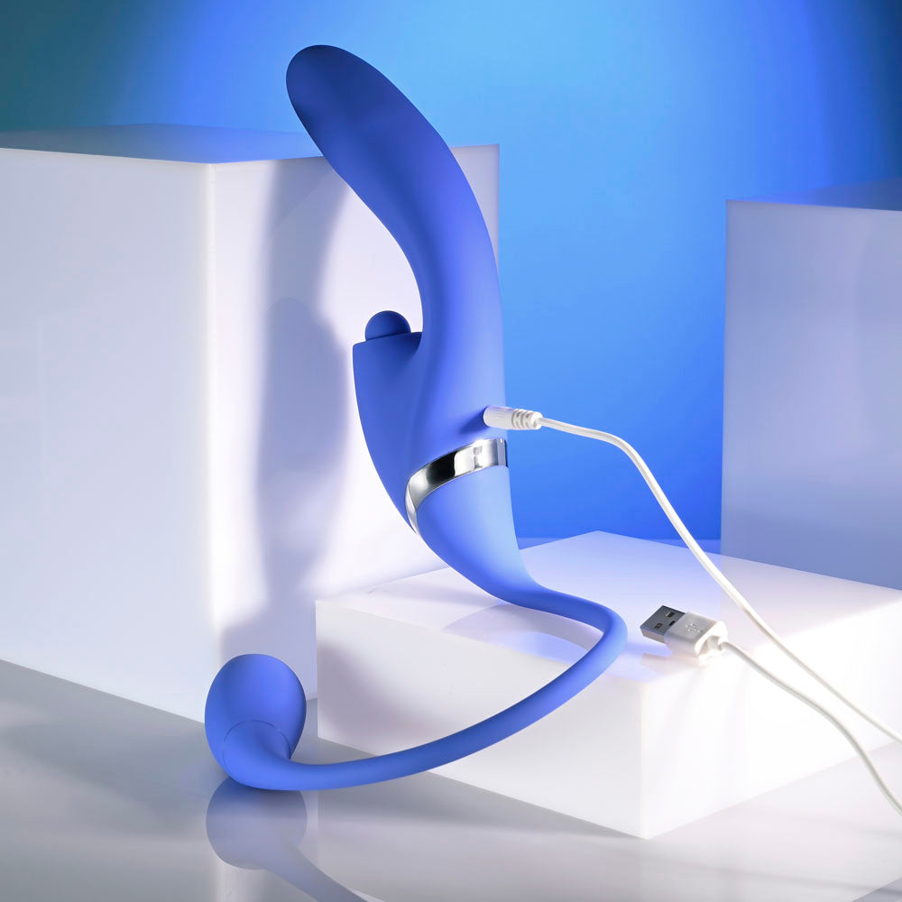 Evolved ALL IN -  USB Recahrgeable Triple Stimulating Vibrator charging on a sleek white surface with blue lighting.