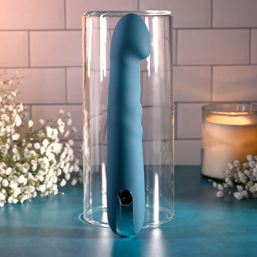 Evolved QUEEN OF ALL TRADES - 22.6 cm USB Rechargeable Thrusting & Rotating Vibrator displayed in a glass container.