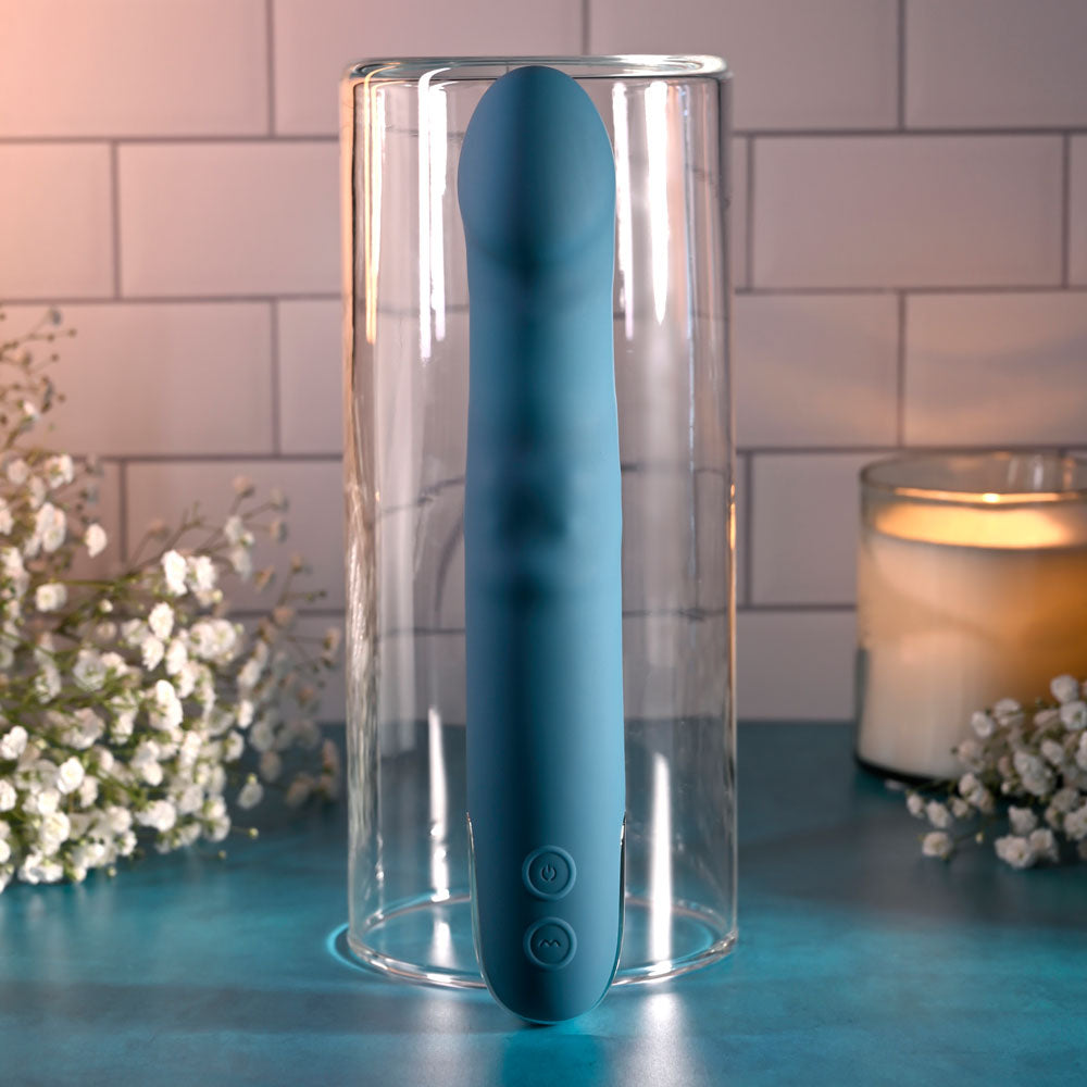 Evolved QUEEN OF ALL TRADES - 22.6 cm USB Rechargeable Thrusting & Rotating Vibrator displayed in a glass container.