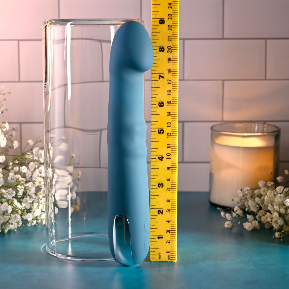 Evolved QUEEN OF ALL TRADES - 22.6 cm USB Rechargeable Thrusting & Rotating Vibrator next to a measuring tape for size reference.
