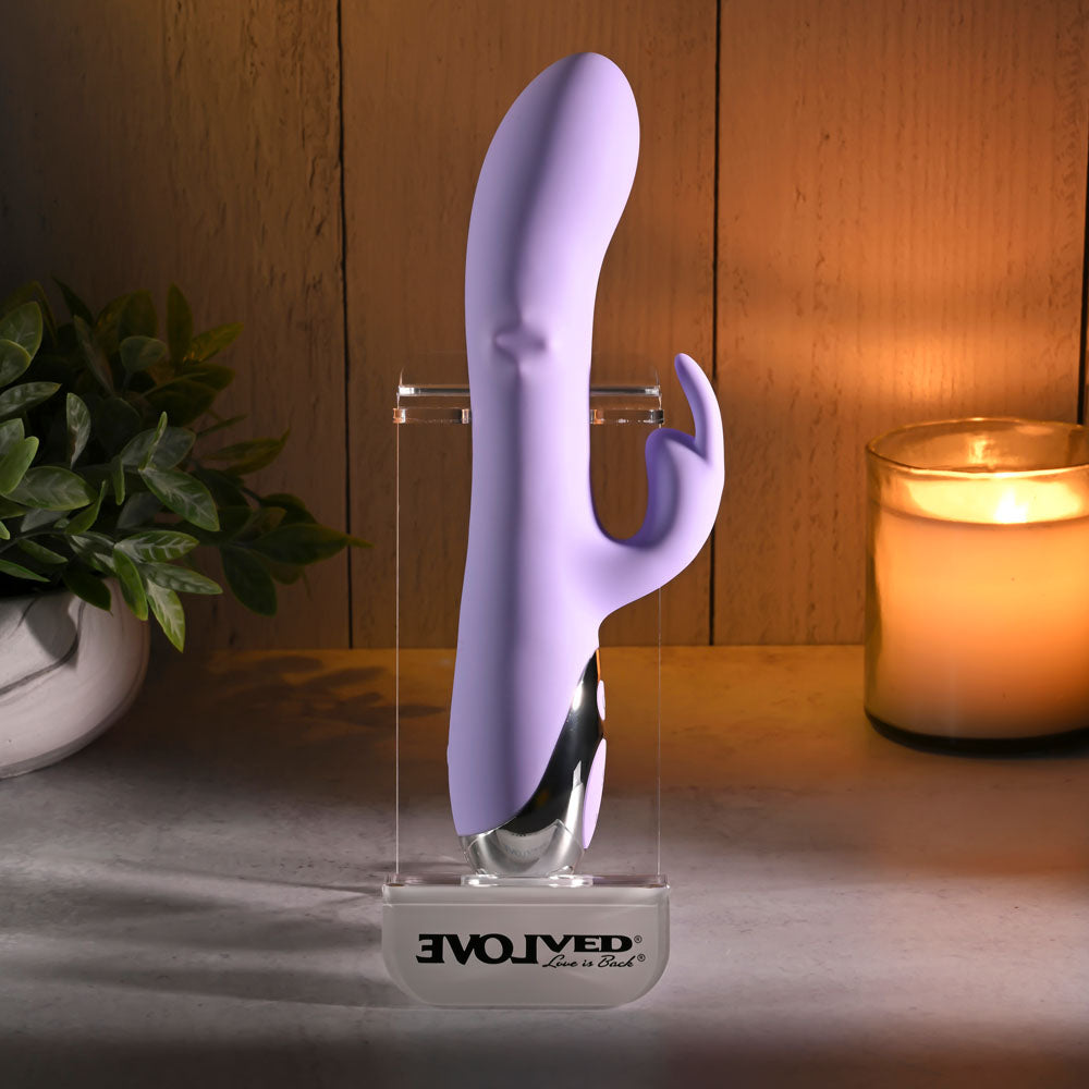 Evolved SPINDERELLA -  USB Rechargeable Rabbit Vibrator on display with candle and plants.
