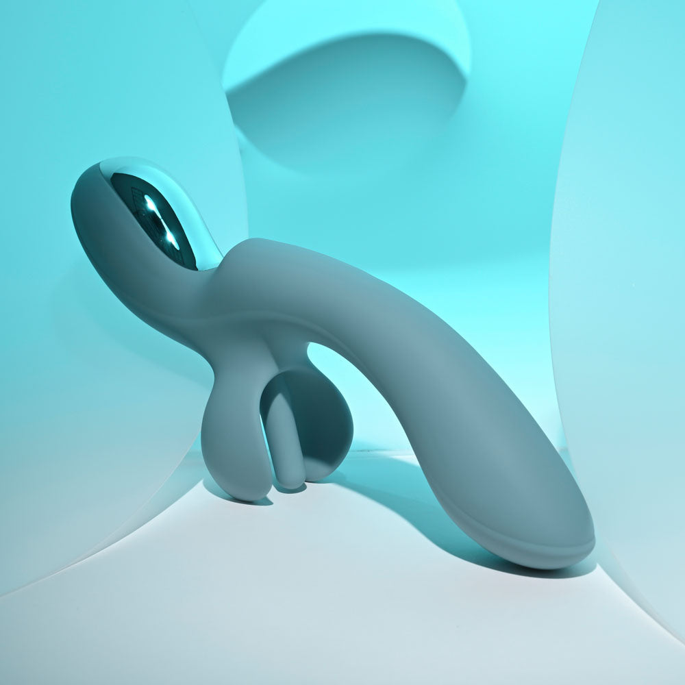 Evolved TAKE YOUR FLICK - Grey 24.1 cm USB Rechargeable Vibrator with Flicking Clitoral Stimulator on a soft surface.
