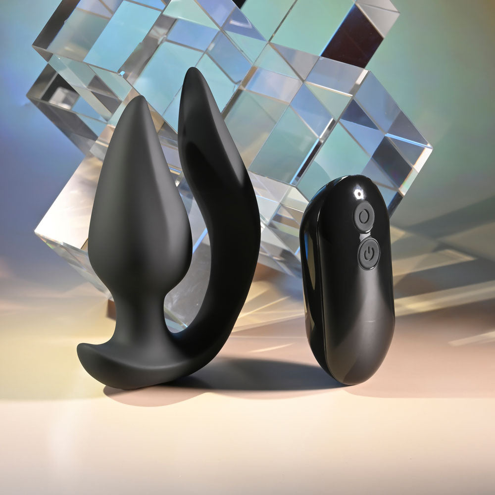 Evolved THE GENIE -  11.2 cm USB Rechargeable Vibrating Plug with Wireless Remote alongside a sleek remote control.