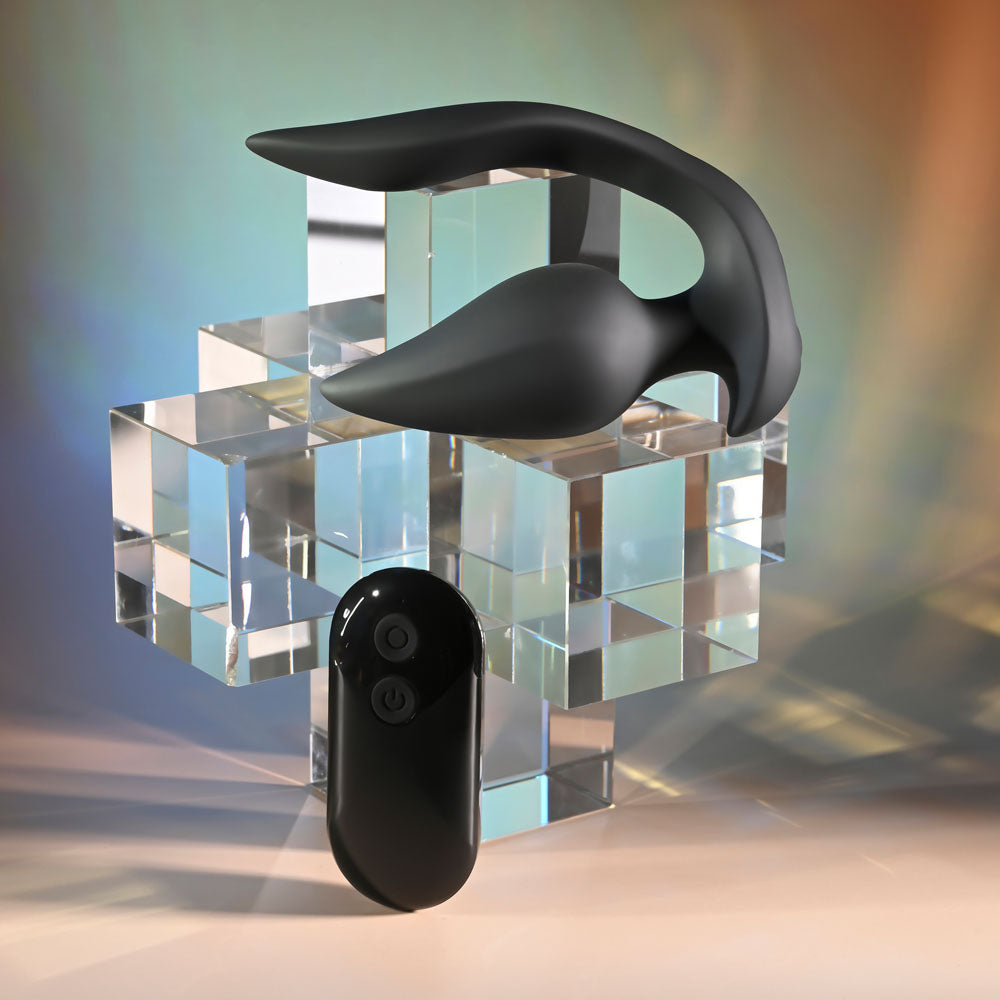 Evolved THE GENIE -  11.2 cm USB Rechargeable Vibrating Plug with Wireless Remote displayed on crystal blocks.