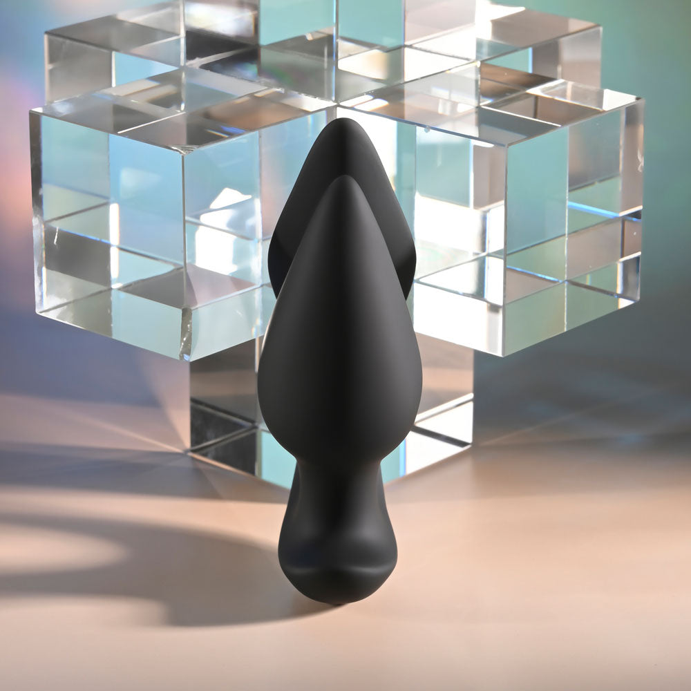 Evolved THE GENIE -  11.2 cm USB Rechargeable Vibrating Plug with Wireless Remote on a geometric background.