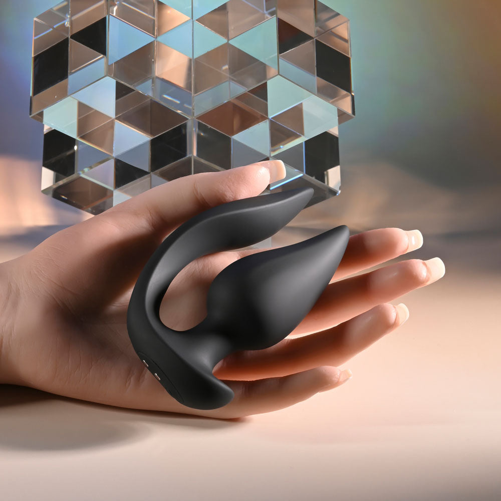 Evolved THE GENIE -  11.2 cm USB Rechargeable Vibrating Plug with Wireless Remote held in a hand.