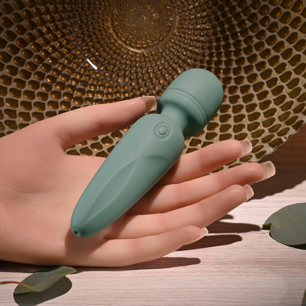 Evolved RUMBLE WAND - Olive  13.4 USB Rechargeable Mini Massage Wand held in a hand, showcasing its silicone design.