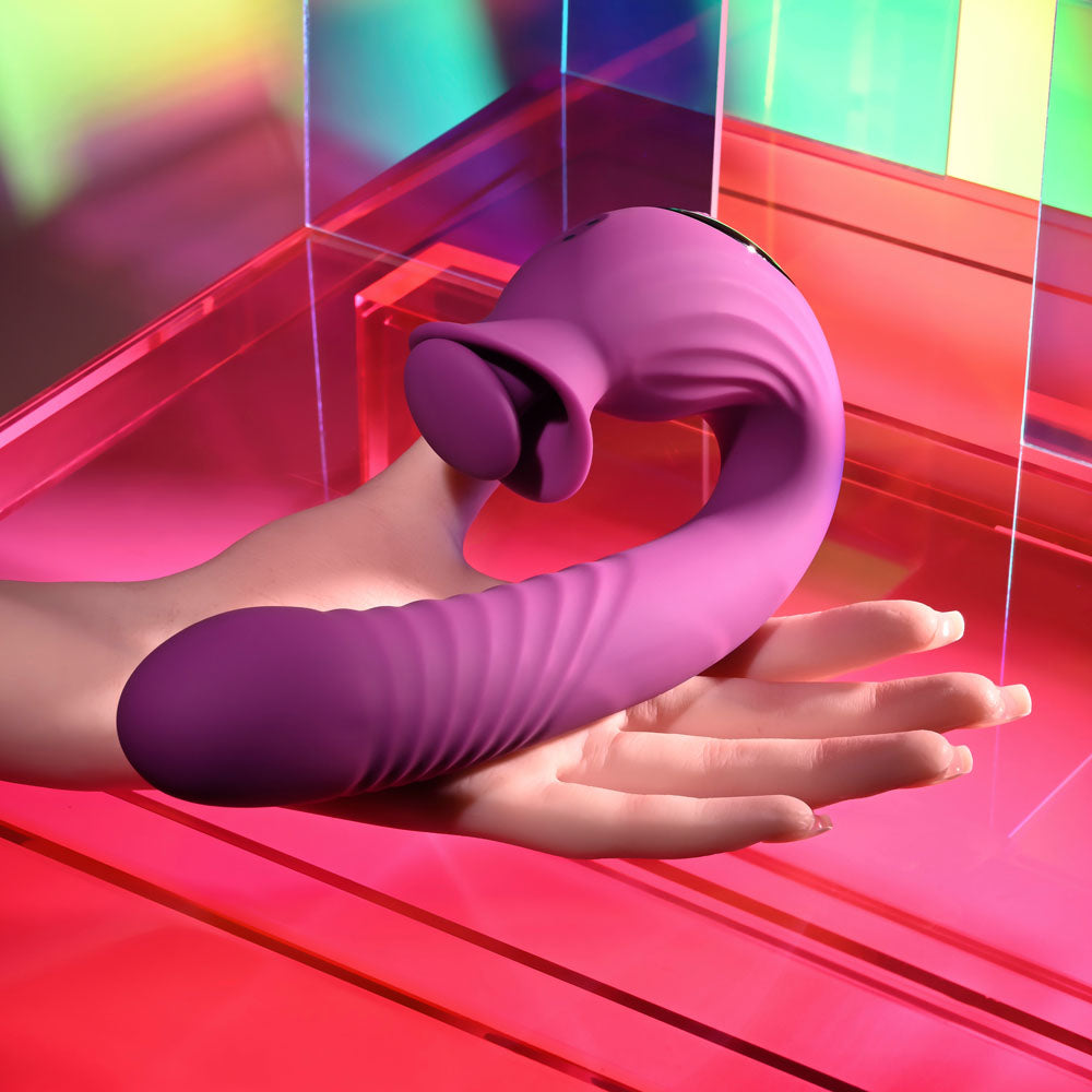 Evolved DEEP ECSTASY USB rechargeable thrusting vibrator on a hand showcasing its ribbed texture and ergonomic design.