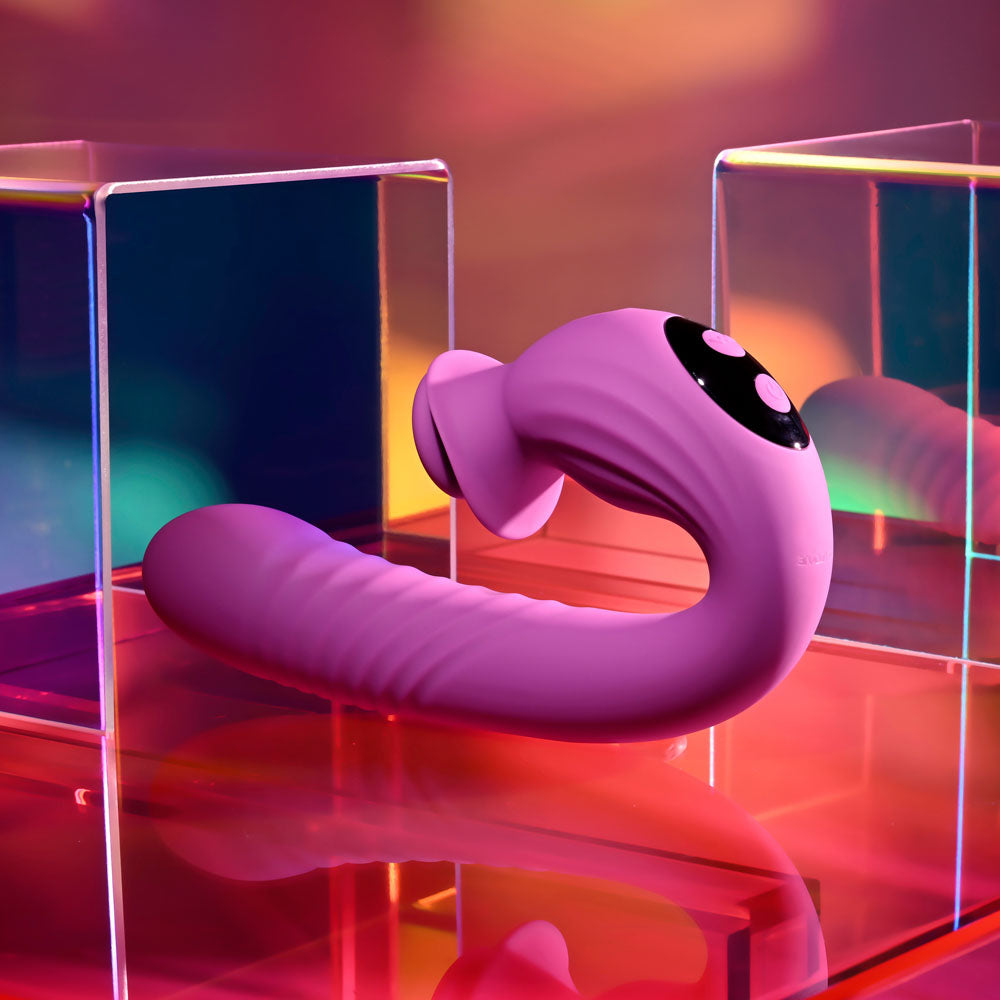 Evolved DEEP ECSTASY USB rechargeable thrusting vibrator displayed in colorful lighting.