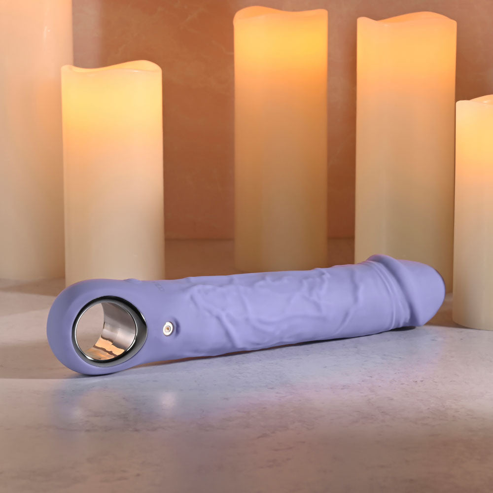 Evolved LARGE FANTASY - 21.8 cm USB Rechargeable Vibrator surrounded by glowing candles for a sensual ambiance.