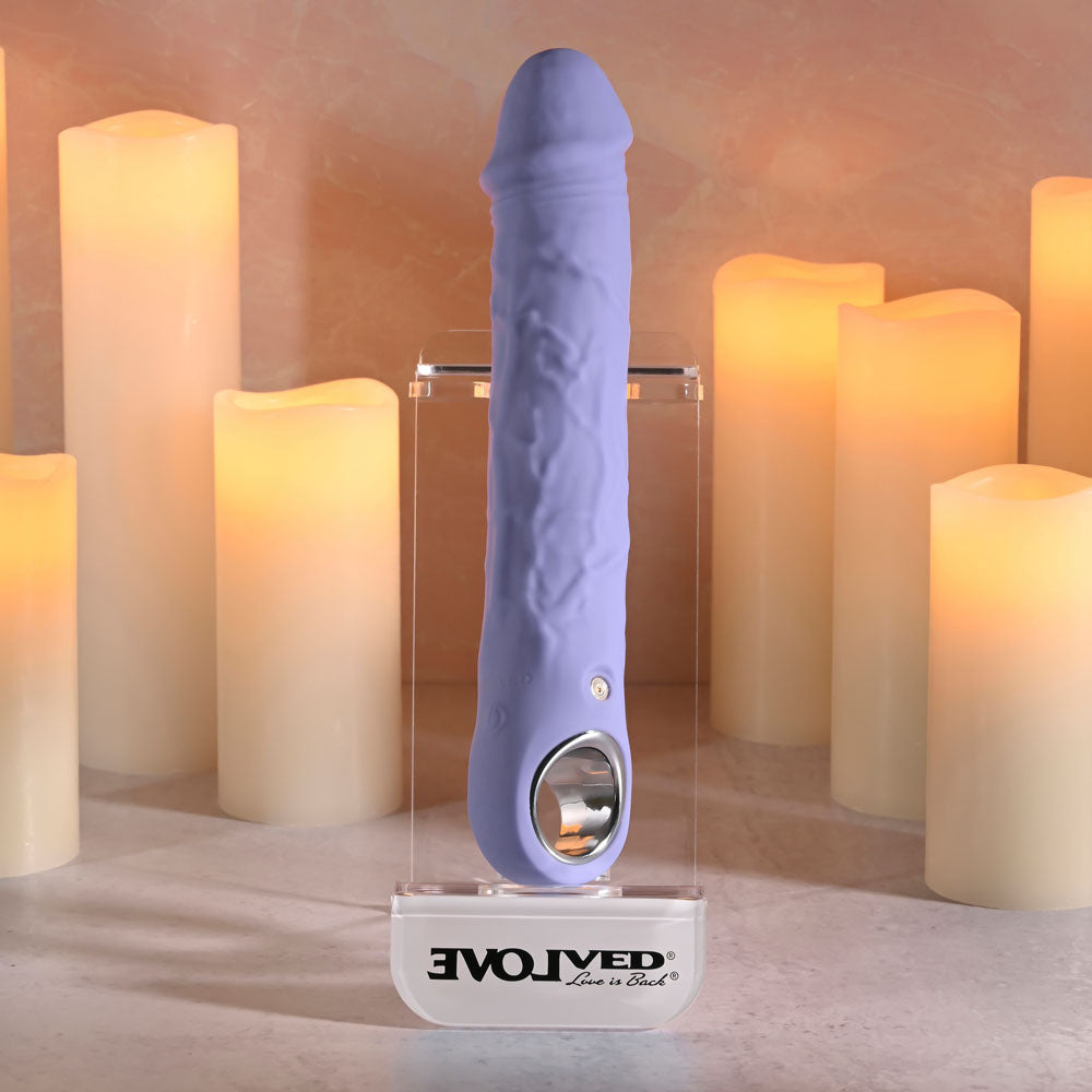 Evolved LARGE FANTASY - 21.8 cm USB Rechargeable Vibrator displayed among lit candles, showcasing its lifelike design.