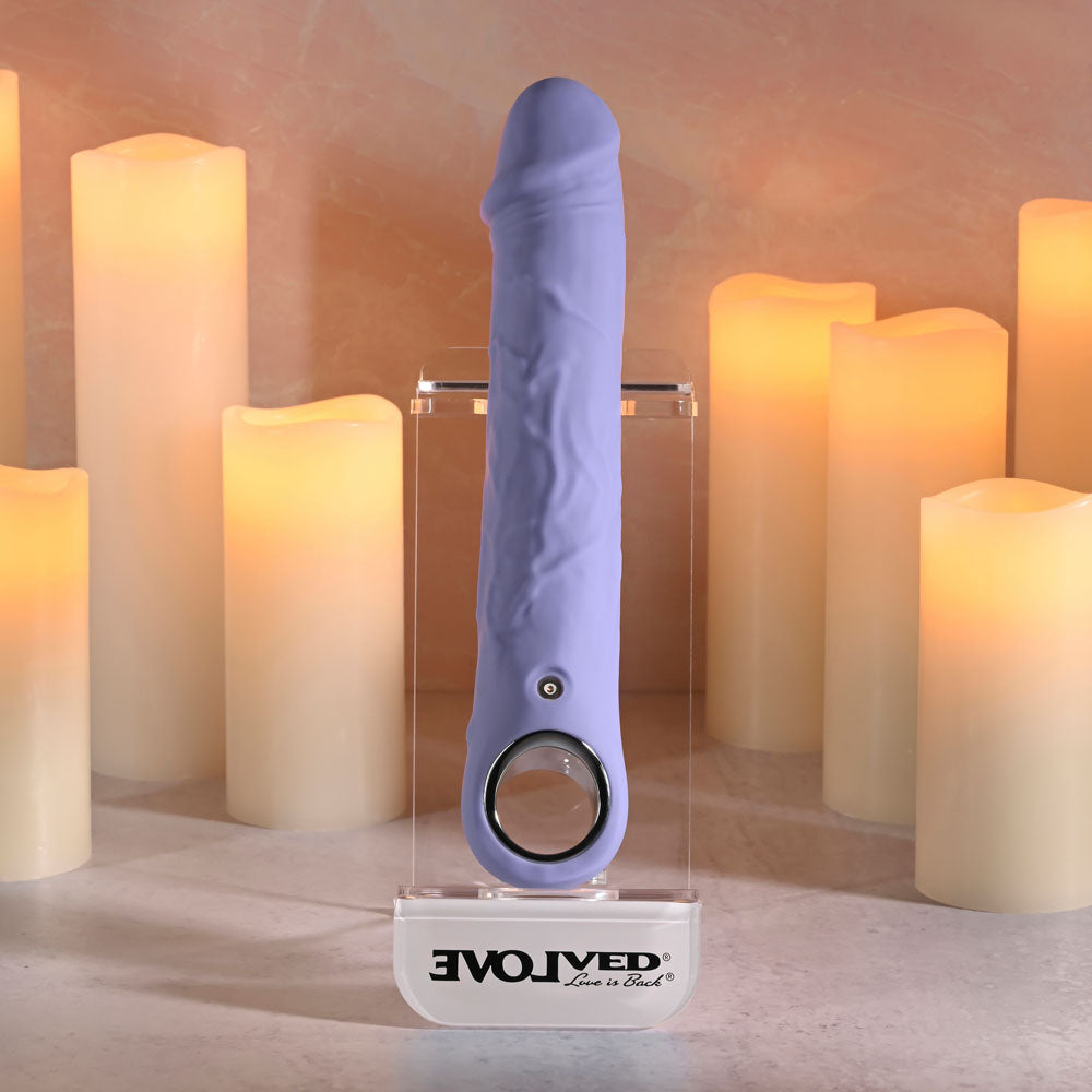 Evolved LARGE FANTASY - 21.8 cm USB Rechargeable Vibrator displayed among soft candlelight for a sensual ambiance.