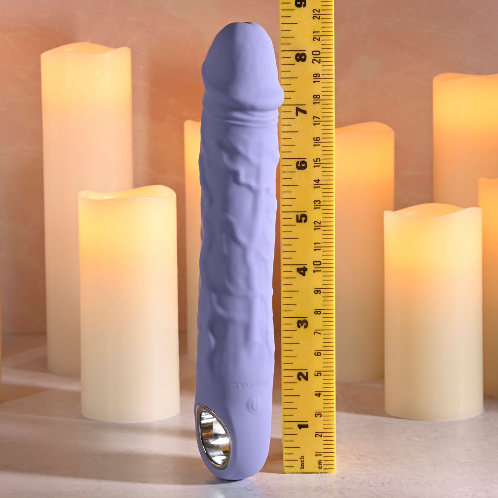Evolved LARGE FANTASY - 21.8 cm USB Rechargeable Vibrator next to a ruler, surrounded by soft glowing candles.