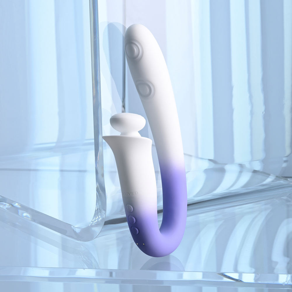 Evolved SPRING LOADED - /Purple 23 cm USB Rechargeable Multi-Tapping Vibrator displayed on a reflective surface.