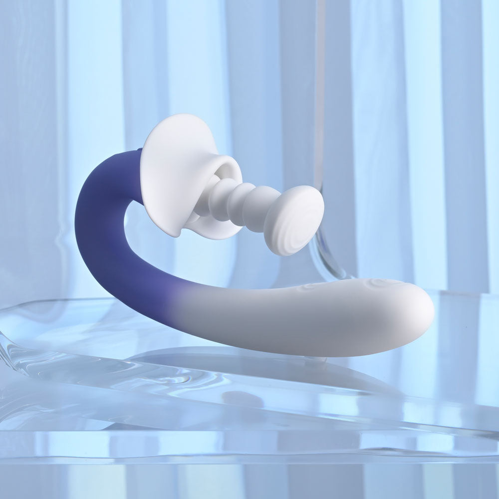 Evolved SPRING LOADED - /Purple 23 cm USB Rechargeable Multi-Tapping Vibrator on a smooth surface, showcasing its design.