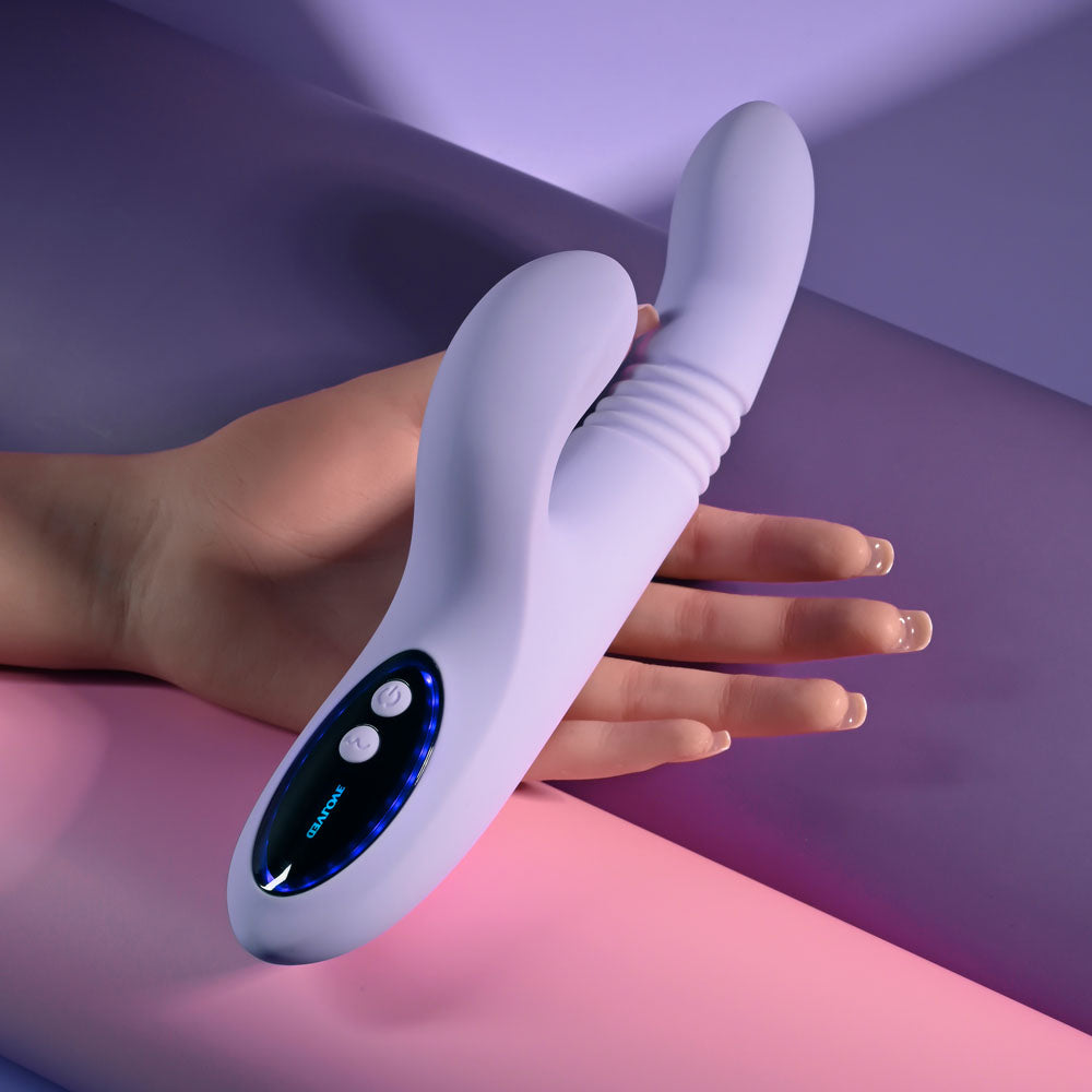 Evolved PEP TALK - 23.3 cm USB Rechargeable Thrusting Vibrator with Tapping Clitoral Stimulator in hand on a colorful background.