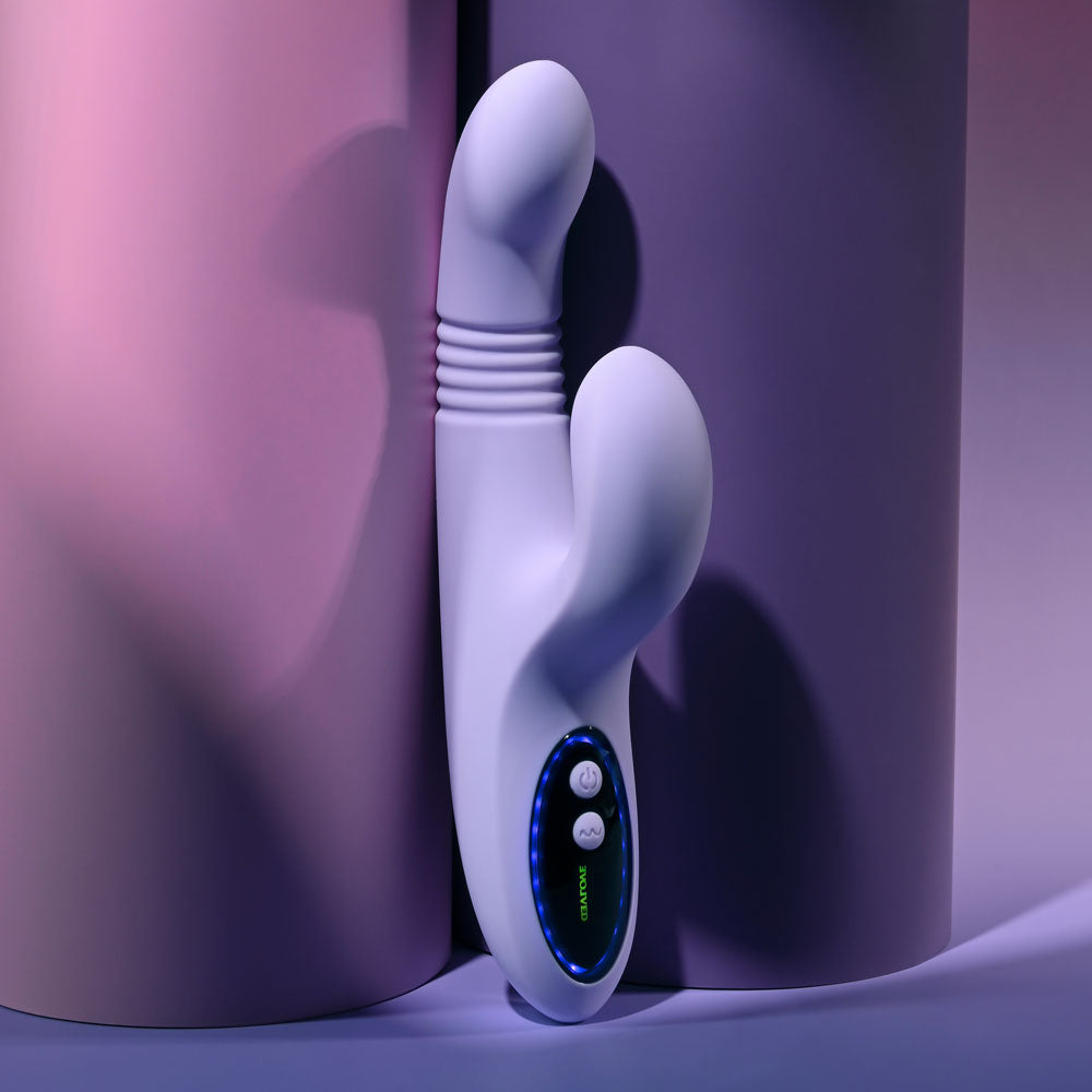 Evolved PEP TALK - 23.3 cm USB Rechargeable Thrusting Vibrator with Tapping Clitoral Stimulator against pastel cylinders.
