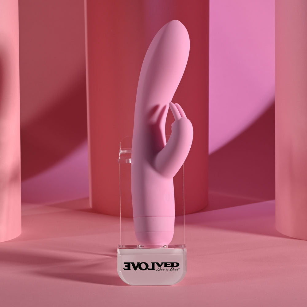 Evolved CUSHY BUNNY -  19.1 cm USB Rechargeable Rabbit Vibrator on display against a pink background.