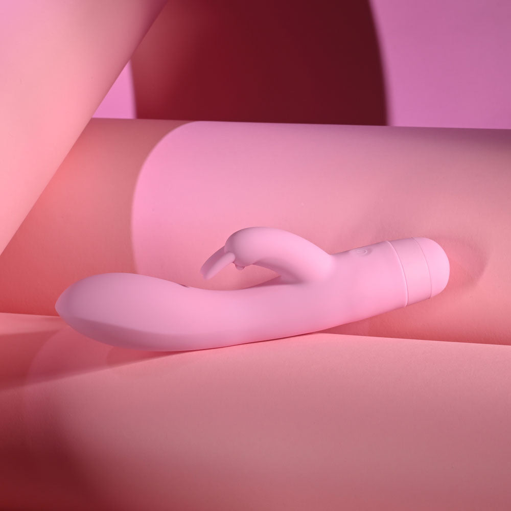 Evolved CUSHY BUNNY - 19.1 cm USB Rechargeable Rabbit Vibrator on a soft pink background.