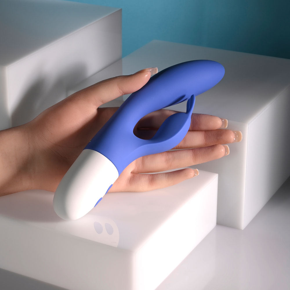 Evolved FUNNY BUNNY - 20 cm USB Rechargeable Rabbit Vibrator in a hand, showcasing its ergonomic design.